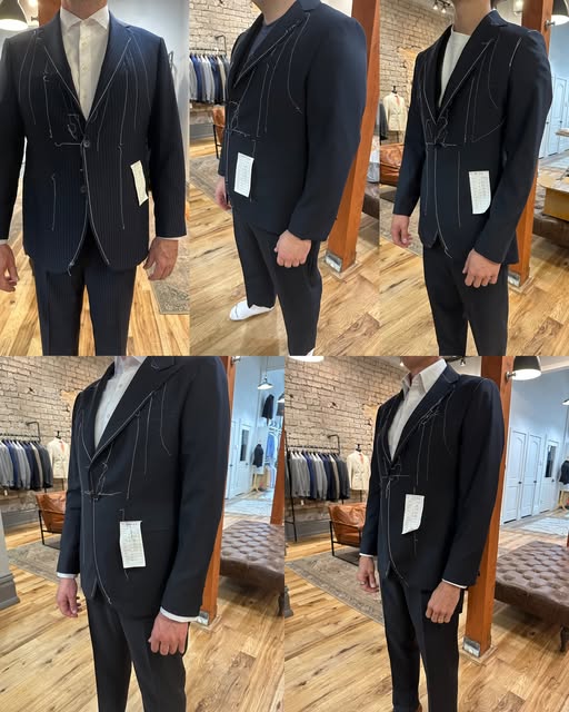 Navy and pinstripe custom suits with basted fitting stitches, being fitted in the downtown Provo store