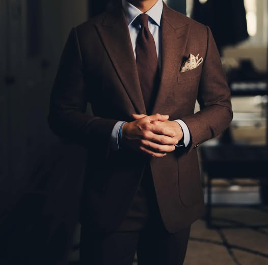 A tailored chocolate-brown custom suit with a light shirt and pocket square by Perfectly Suited